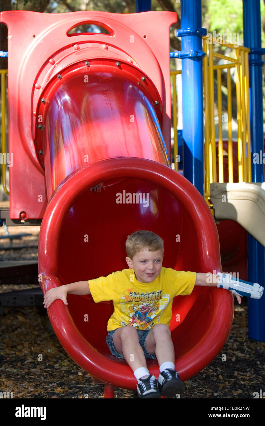 3 year old boy playing on playground equipment at a park in Tampa Florida Stock Photo