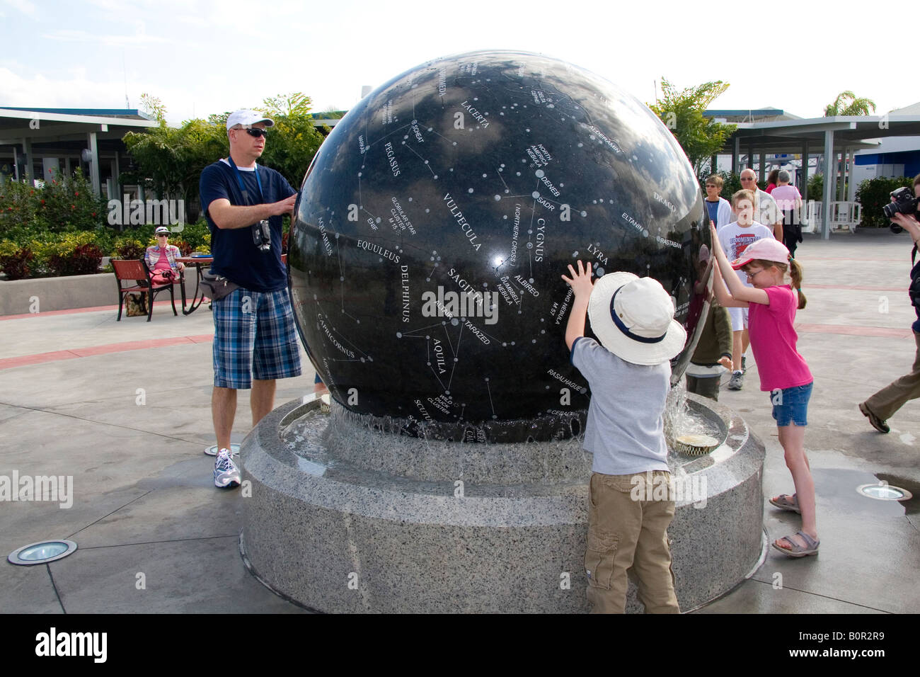 Children push the Constellation Sphere at the Kennedy Space Center Visitor Complex in Cape Canaveral Florida Stock Photo