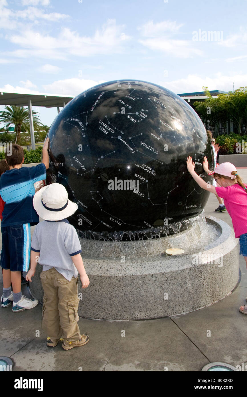Children push the Constellation Sphere at the Kennedy Space Center Visitor Complex in Cape Canaveral Florida Stock Photo