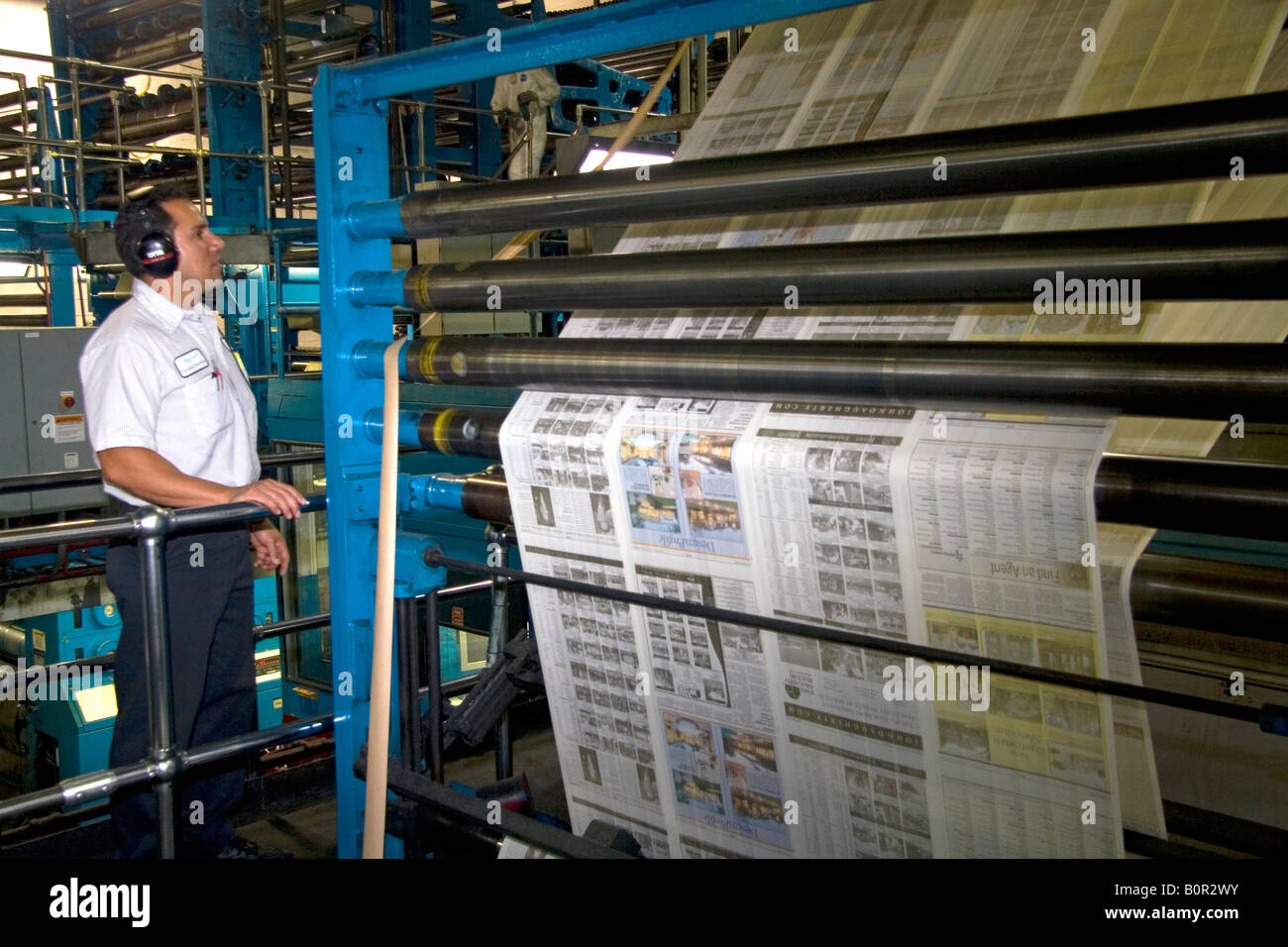 Newspaper being printed on a rotary printing press for the Houston Chronicle in Houston Texas Stock Photo