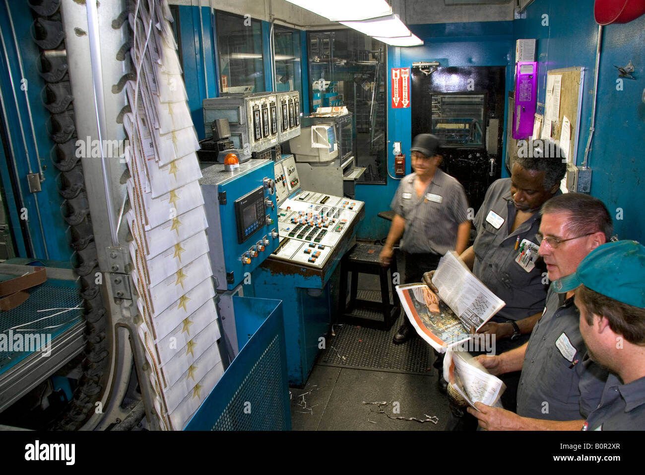 Pressmen in the control room for the rotary printing press at the Houston Chronicle in Houston Texas Stock Photo