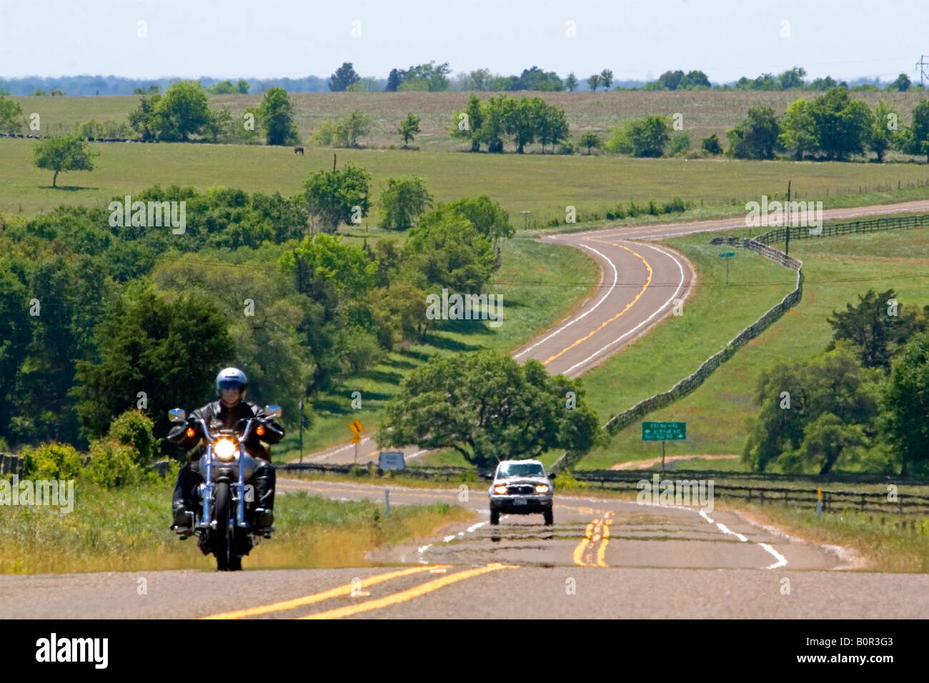 Motorcycle traveling on the Farm to Market Road 390 in Washington County Texas Stock Photo
