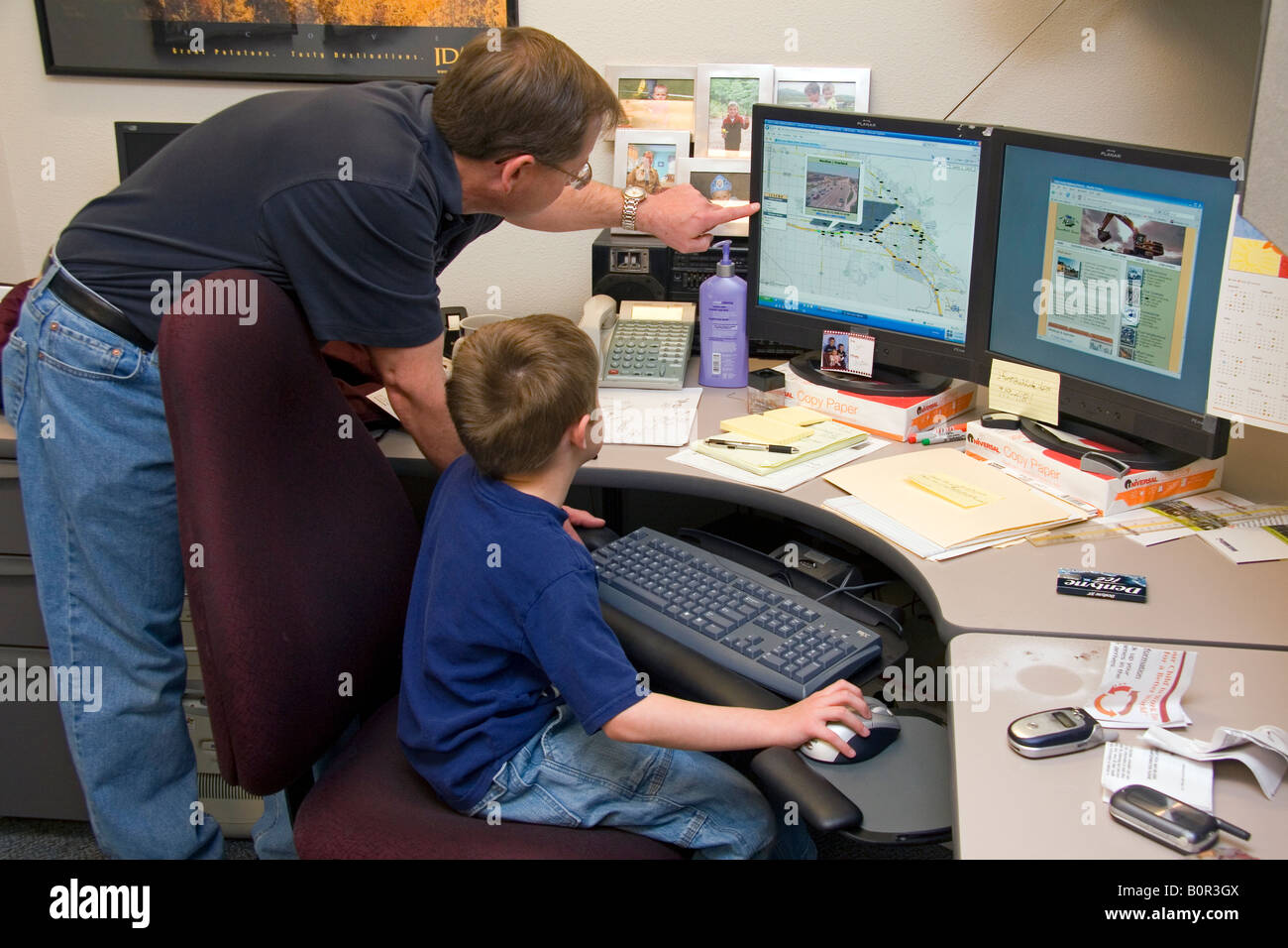Father showing his son what he does at work for the Ada County Highway District in Boise Idaho Stock Photo