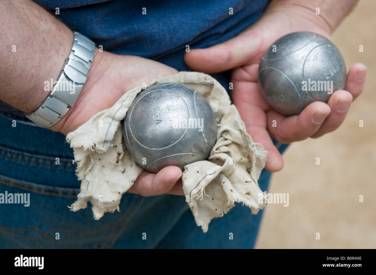 french man holding boule balls in hands, provence, france Stock Photo