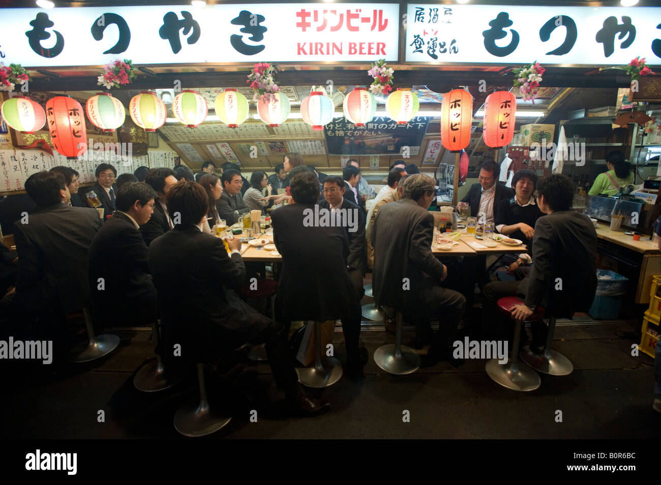Busy restaurant at night under railway tracks at Yurakucho in central Tokyo Japan Stock Photo