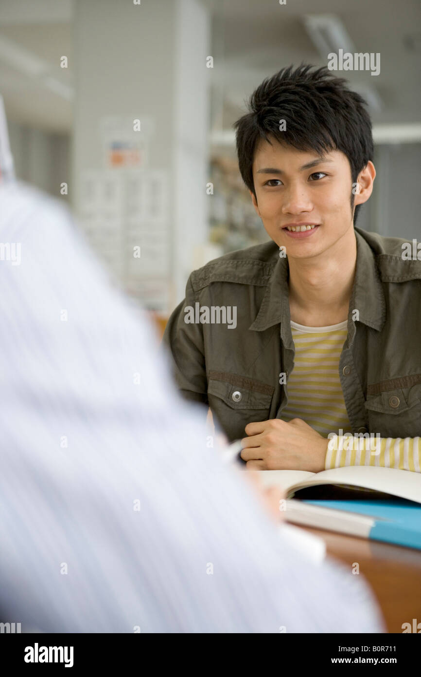 Two men in a library at a writing desk hi-res stock photography and ...