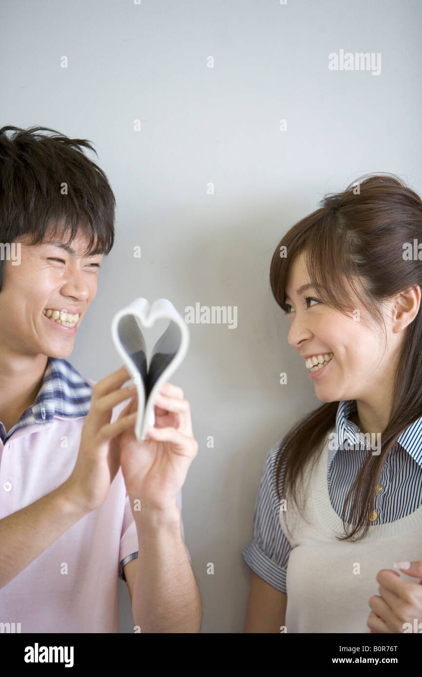 Young man and woman laughing Stock Photo - Alamy