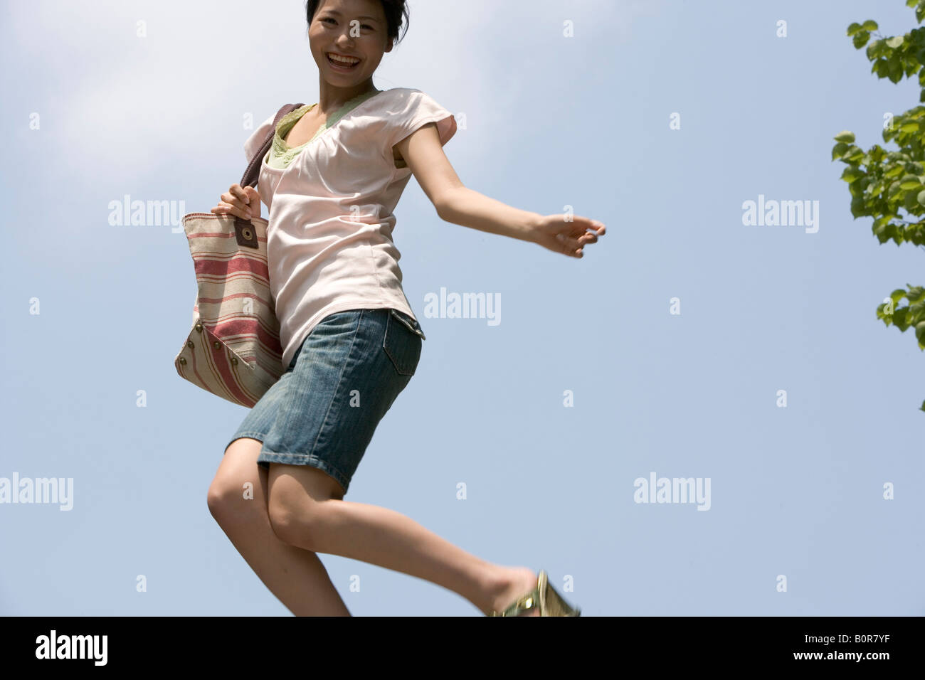 Teenage girl (16-17) jumping against clear sky Stock Photo - Alamy