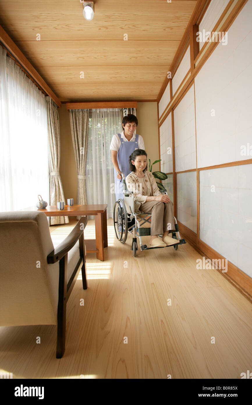 Female nurse pushing elderly woman in wheelchair Stock Photo - Alamy