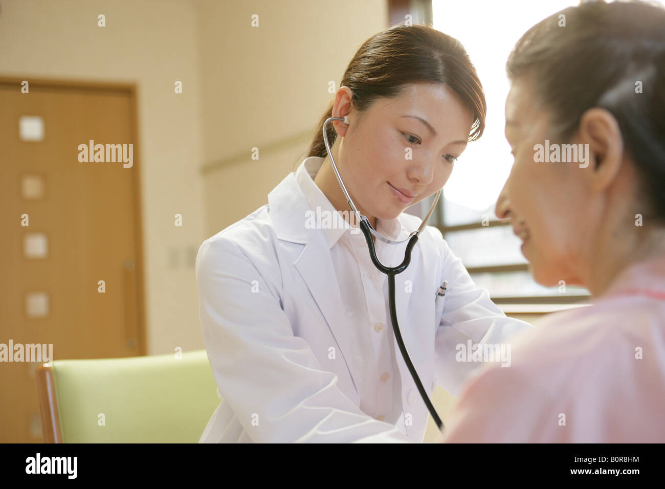 Doctor examining woman in medical hi-res stock photography and images ...