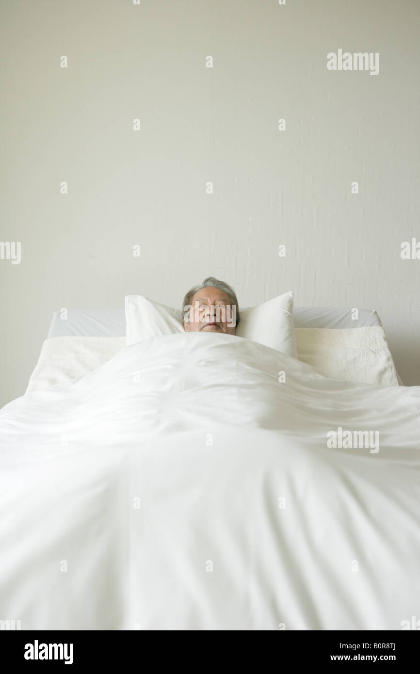 Senior man sleeping in bed Stock Photo - Alamy