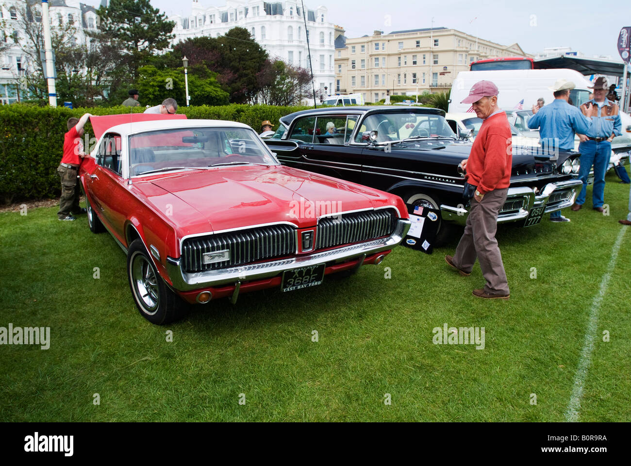 Visitors to Magnificent Motors a classic and vintage car show in Eastbourne admire the cars on display, 3rd May 2008. Stock Photo