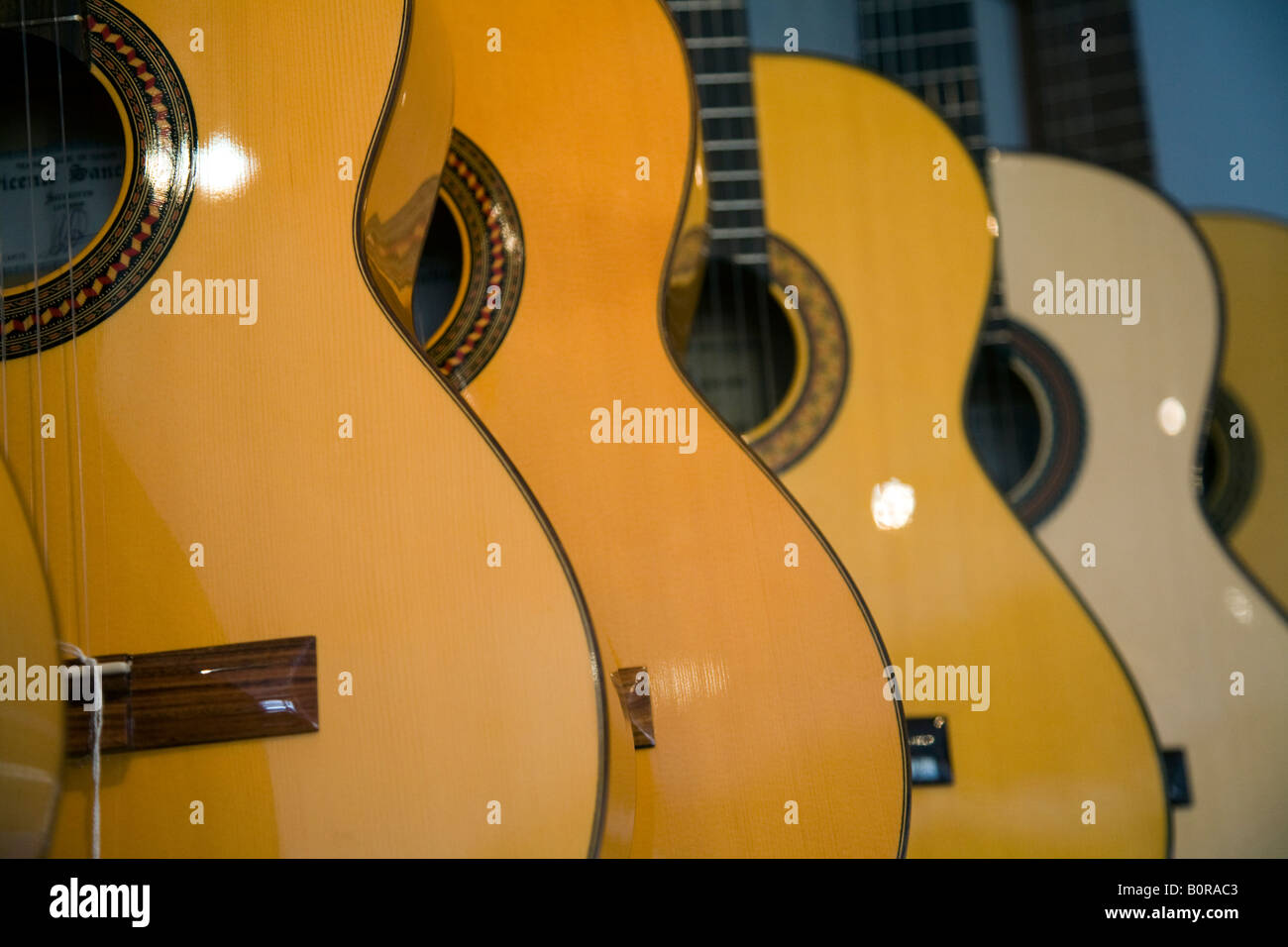 Line of guitars for sale on a musical instruments store, Seville, Spain