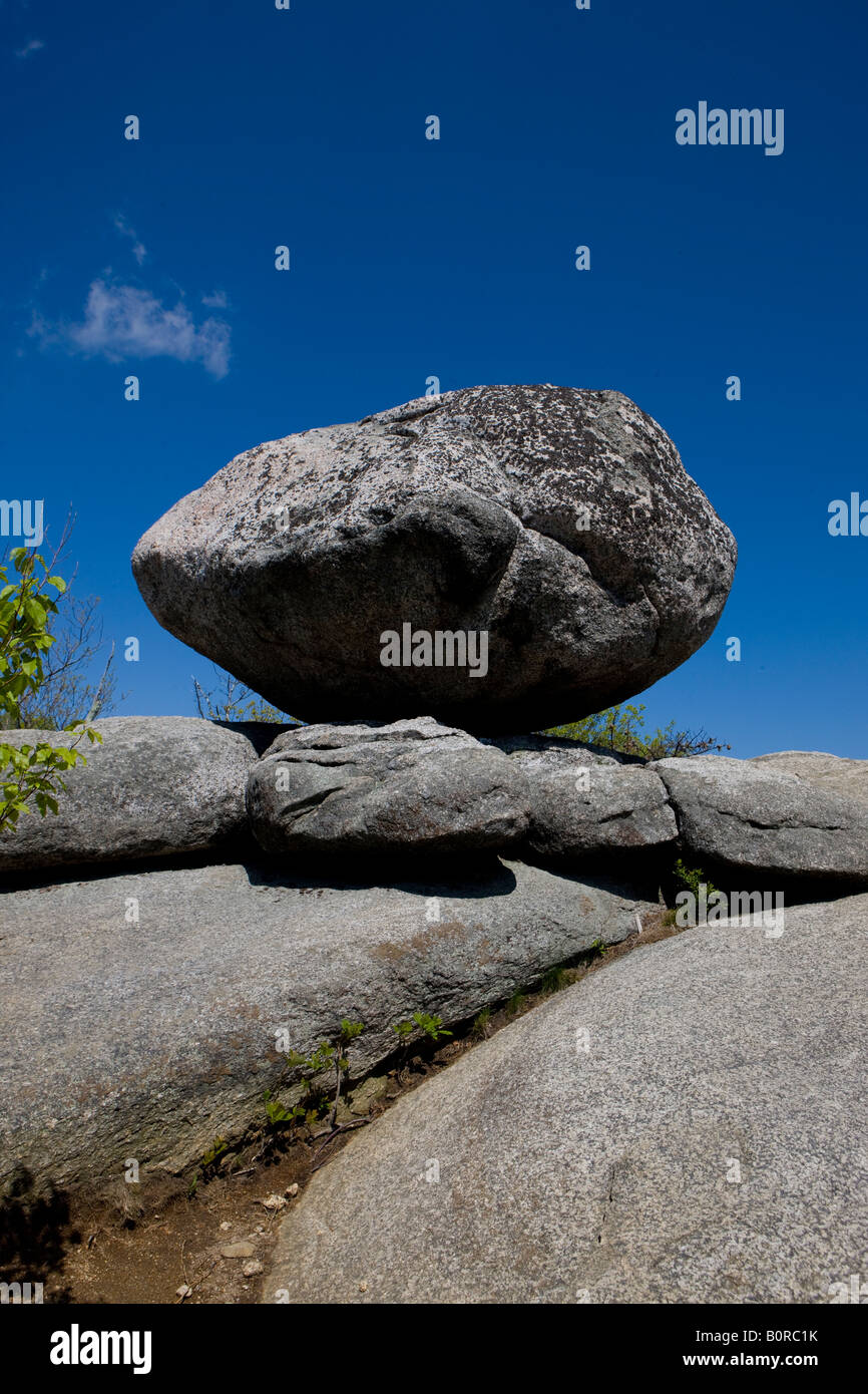 A granite boulder perched with blue sky background near the peak / summit of Old Rag Mt, Shenandoah National Park Virginia USA Stock Photo