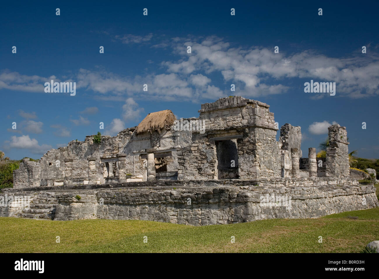 General Aspect of Tulum archaeological site on a bright sunny day with blue sky and white clouds. Stock Photo