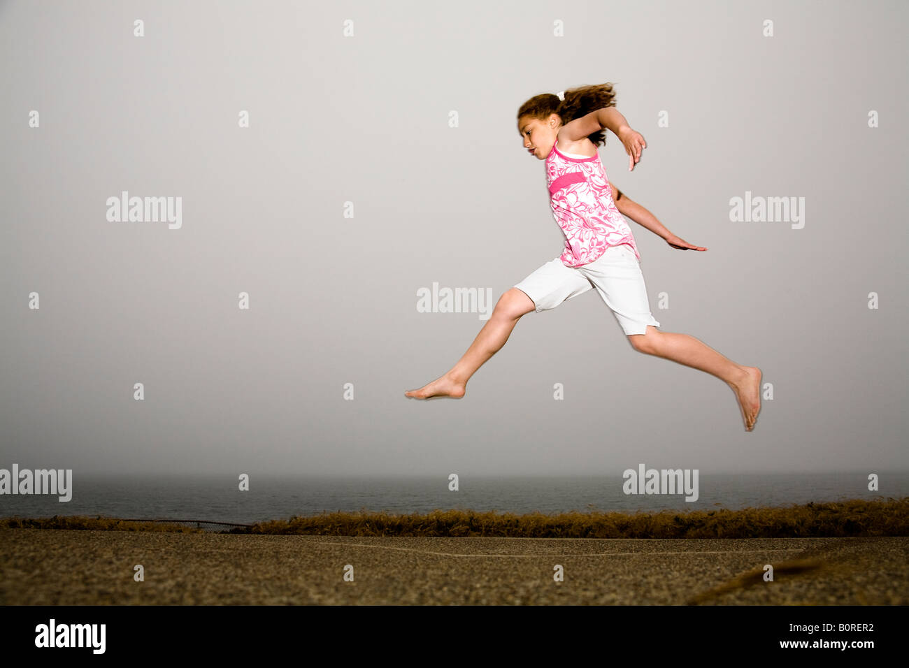 Jump! Leap! Play! Young girl jumping in the air Stock Photo Alamy