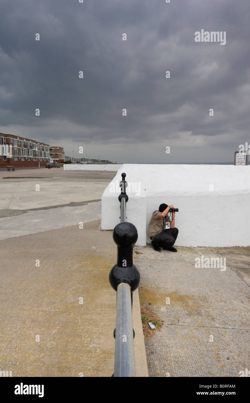 West Kirby seafront and Promenade a view south east A photography student is taking pictures across the marine lake Stock Photo