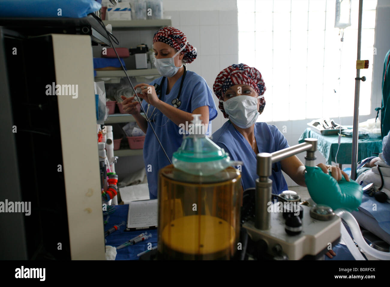 A nurse anesthetist monitors a patient undergoing surgery during a 2006 surgical mission to Sula Santa Barbara hospital in Hondu Stock Photo