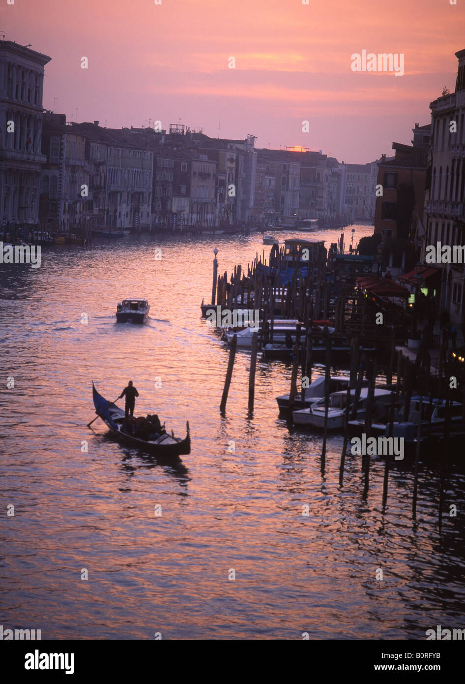 Gondola on Grand Canal at sunset seen from Rialto bridge Venice Veneto Italy Stock Photo