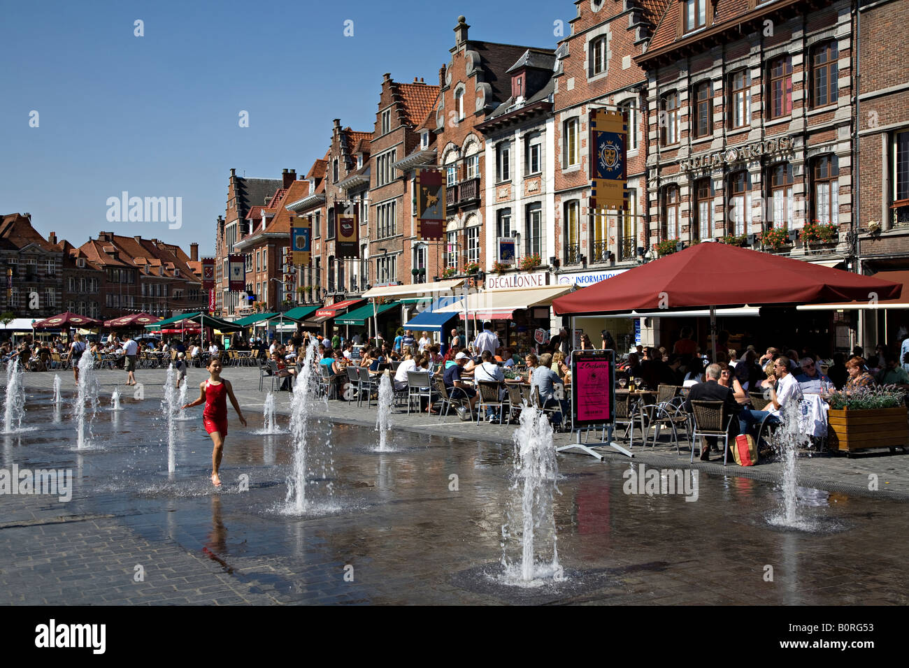 Girl playing in fountains in Grand Place town square Tournai Belgium Stock Photo