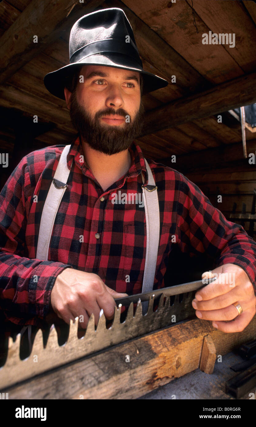 LIVING HISTORY INTERPRETER SHARPENS SAW AT FOREST HISTORY CENTER, GRAND