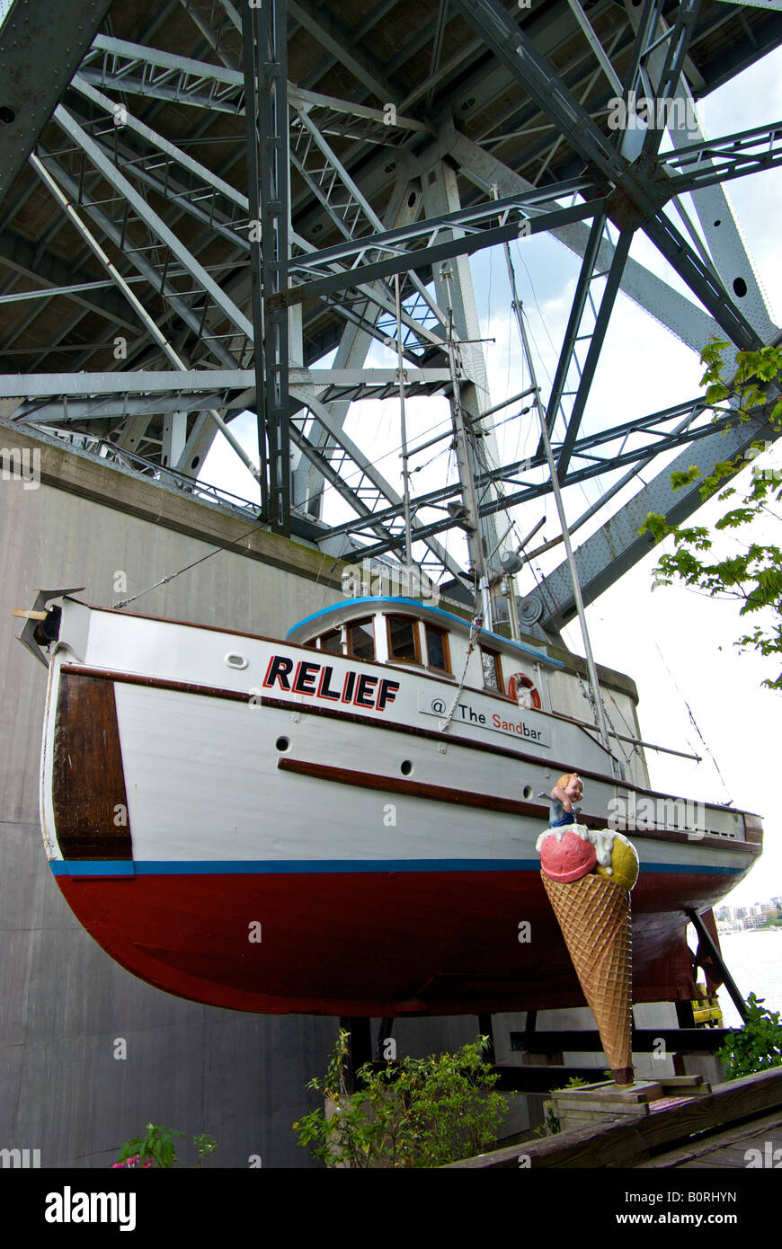 The former commercial wooden fishing vessel Relief dry-docked underneath the Granville street bridge at Granville Island. Stock Photo