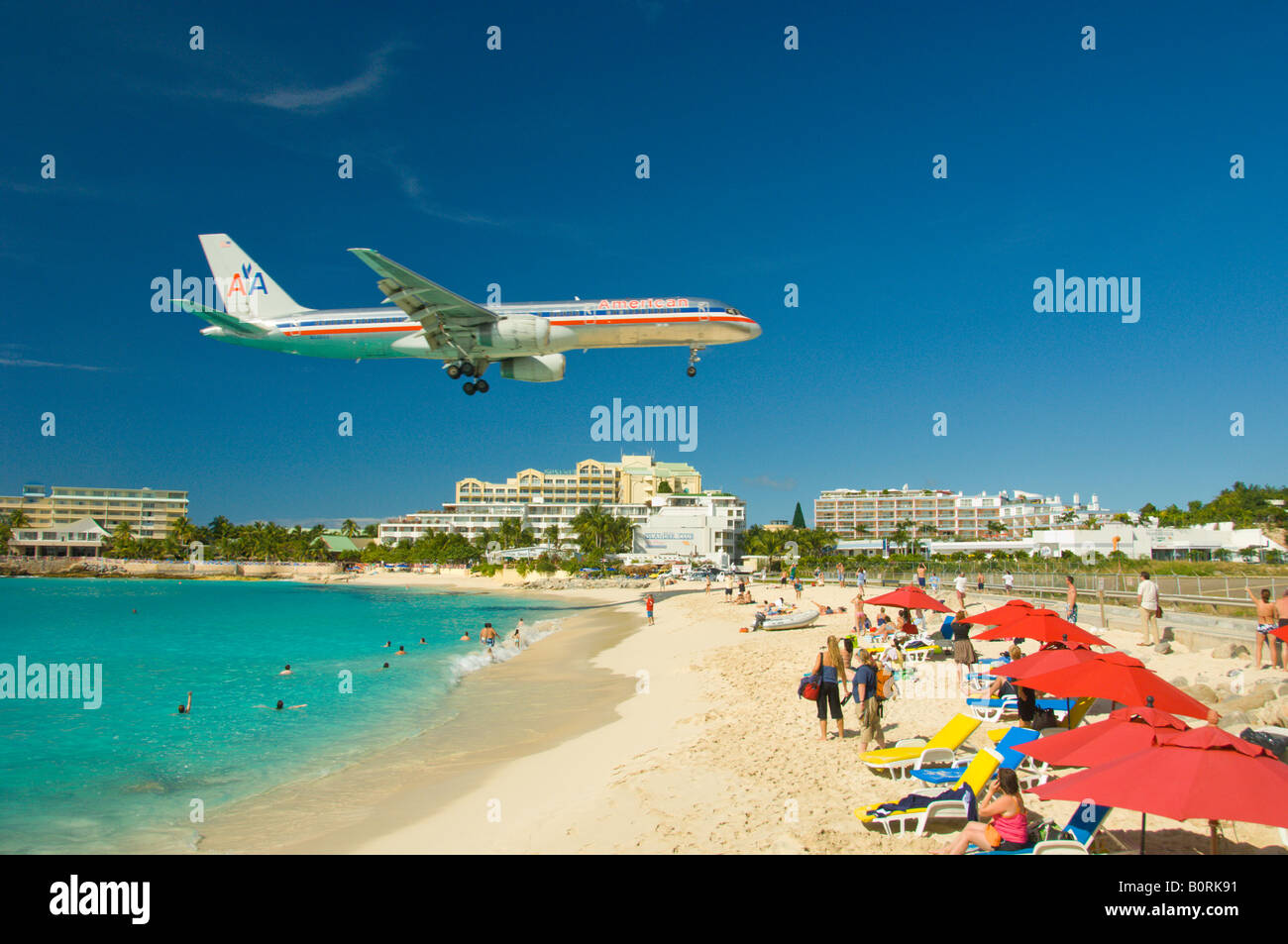 A passenger plane landing over Maho Beach Sint Maarten Netherland Antilles Stock Photo