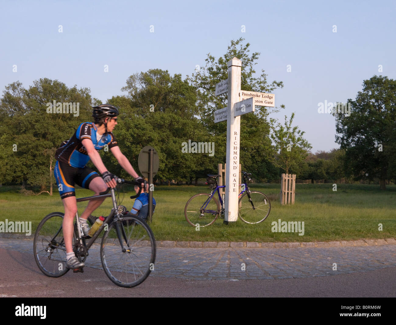 Cyclist near Richmond Gate in Richmond Park, Surrey. UK Stock Photo Alamy