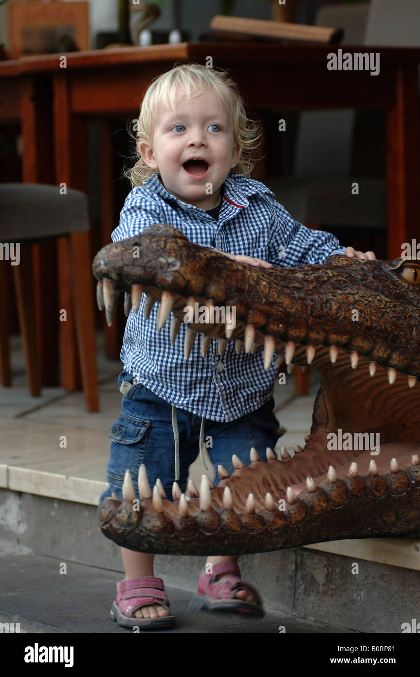 Gran Canaria a toddler boy with a stuffed crocodile in a restaurant in Puerto de Mogan Stock Photo