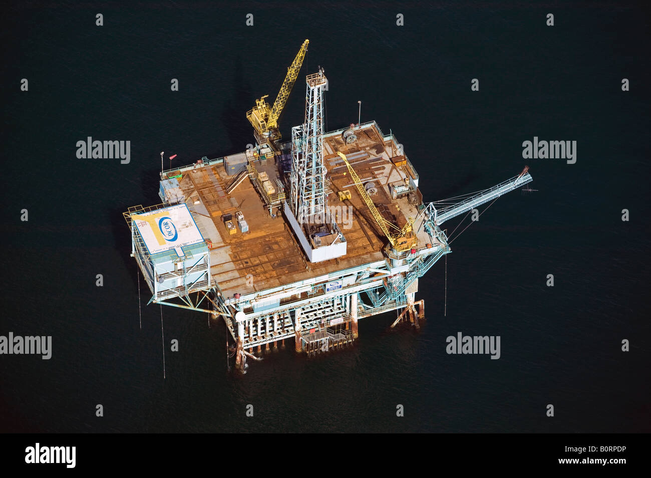 aerial above Pacific coast off shore oil rig platform near Santa Barbara, CA Stock Photo