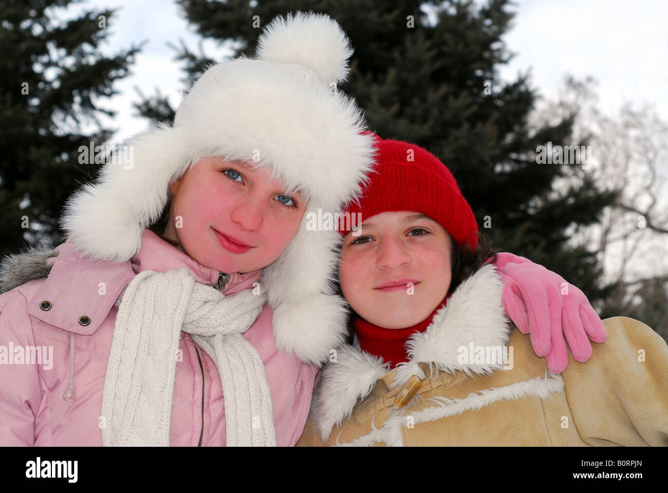 Portrait of two young girls in winter park Stock Photo - Alamy