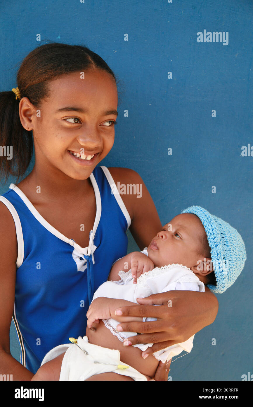 Girl holding a baby, Trinidad, SanctiSpíritus Province, Cuba, Latin