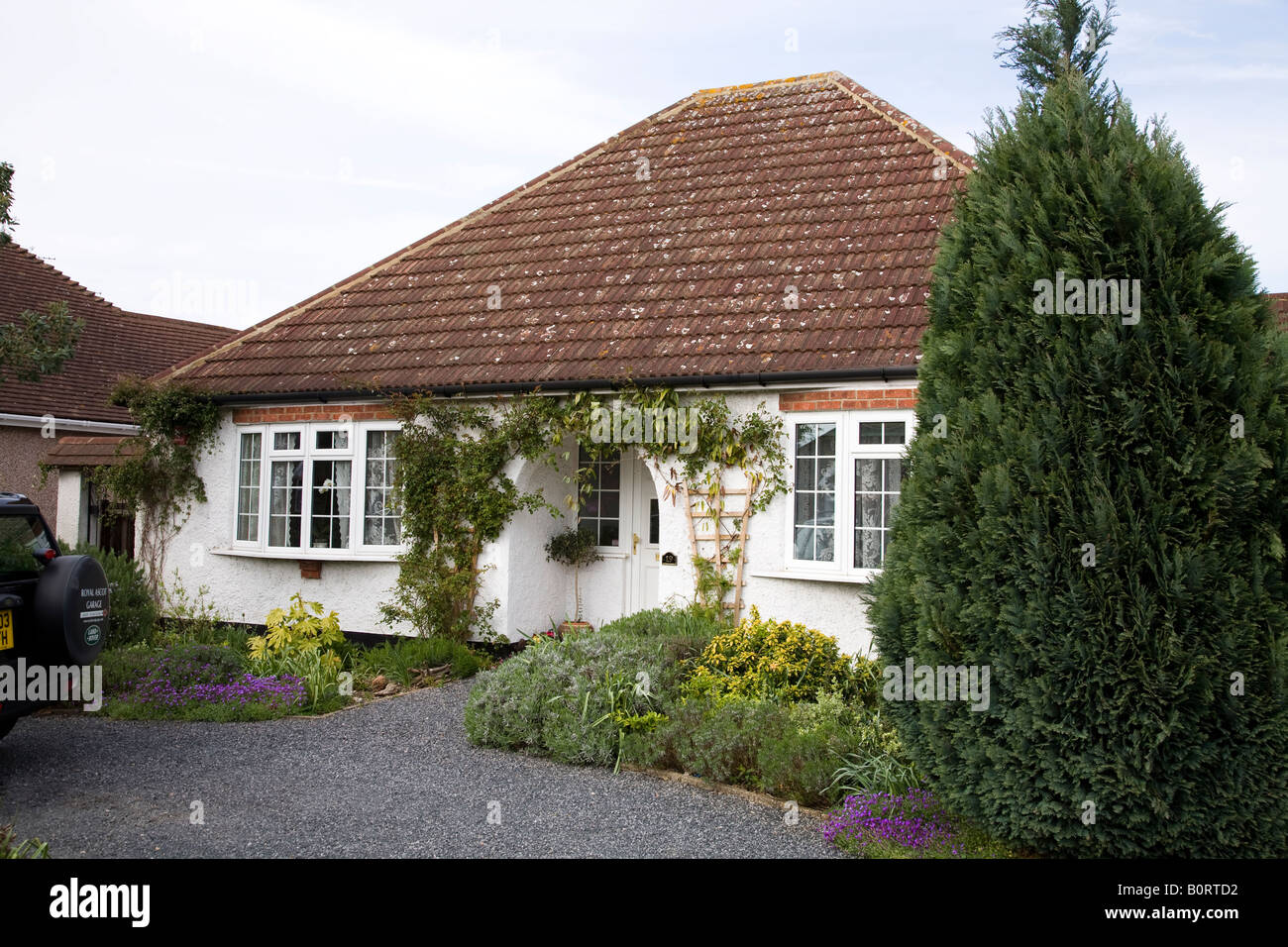 Pretty bungalow home with a gravel driveway in Addlestone, Surrey. UK