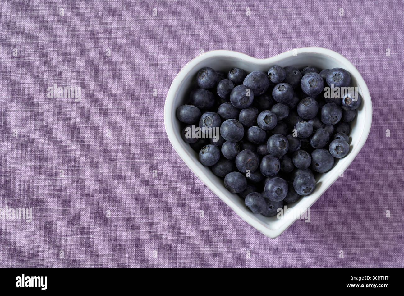 Blueberries in heart shaped bowl Stock Photo Alamy