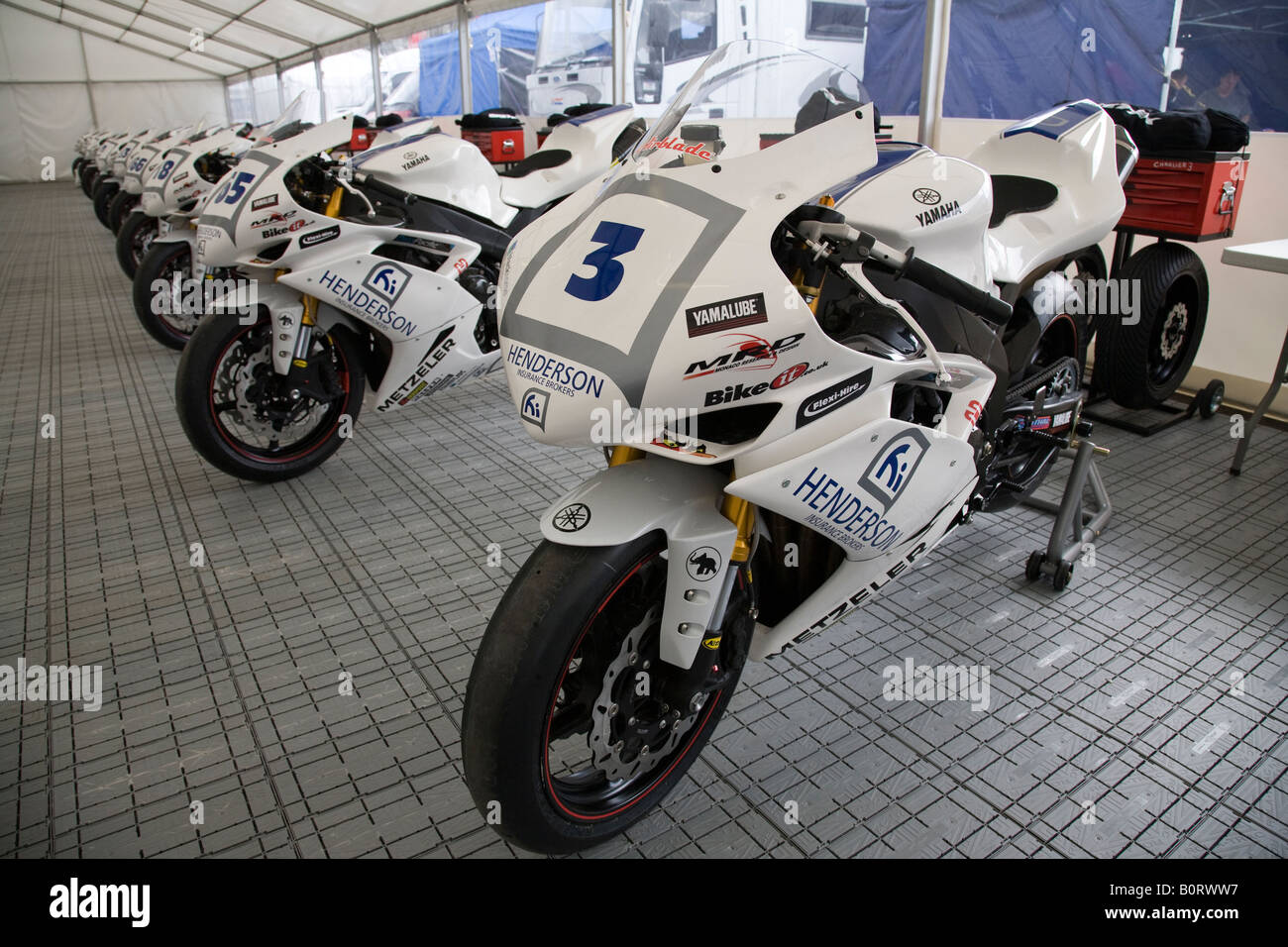 A row of Yamaha R1 motorcycles awaiting their riders in the Henderson Yamaha R1 Cup at Brands Hatch, Kent, England. Stock Photo