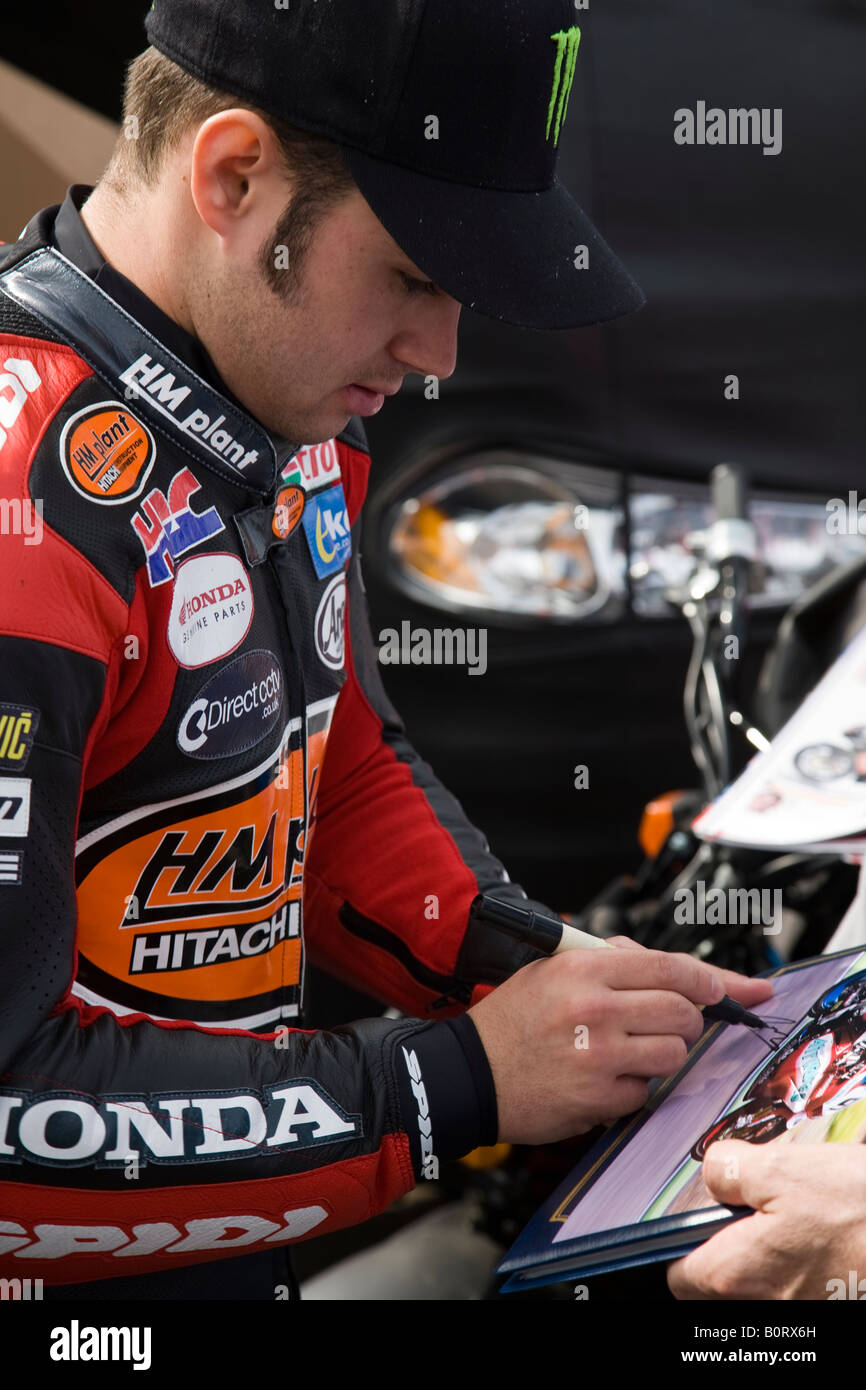 Leon Haslam signing autographs in the paddock during free practice for the British Superbikes Championship at Brands Hatch. Stock Photo