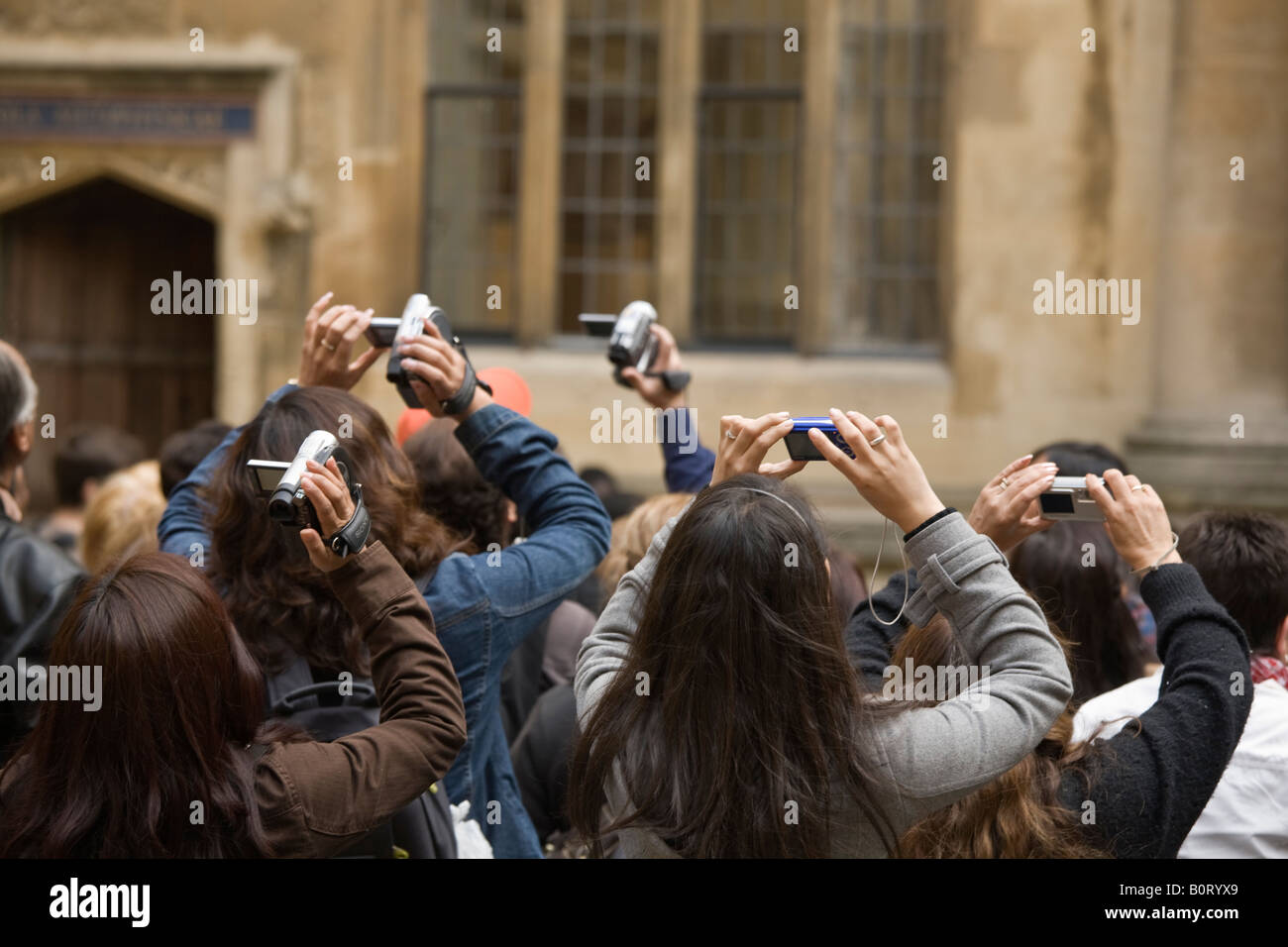 tourists with digital cameras and video camcorders outside the Bodleian Library Oxford Oxfordshire England UK Stock Photo