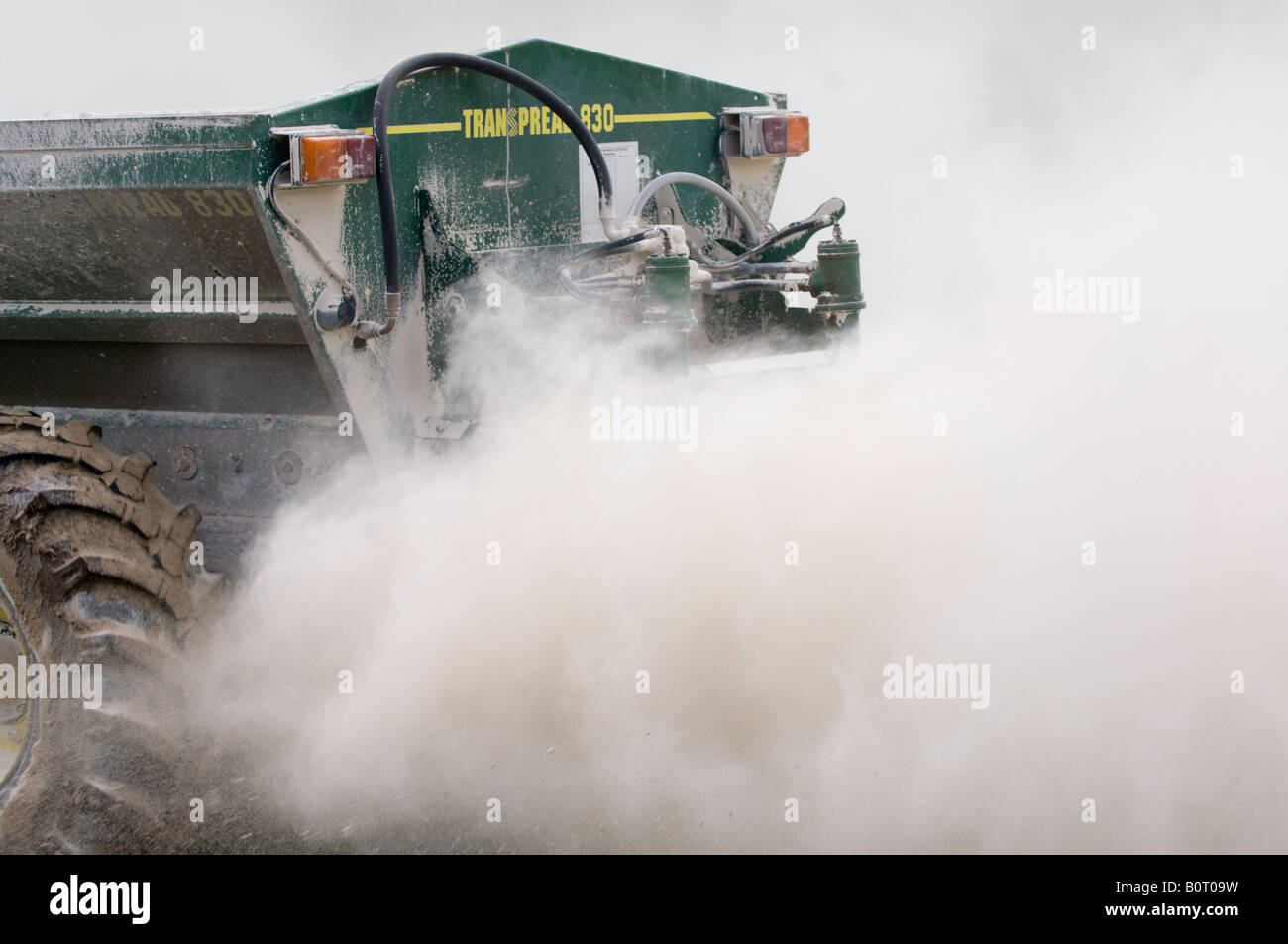 Lime spreader spreading crushed limestone to help improve the fertility