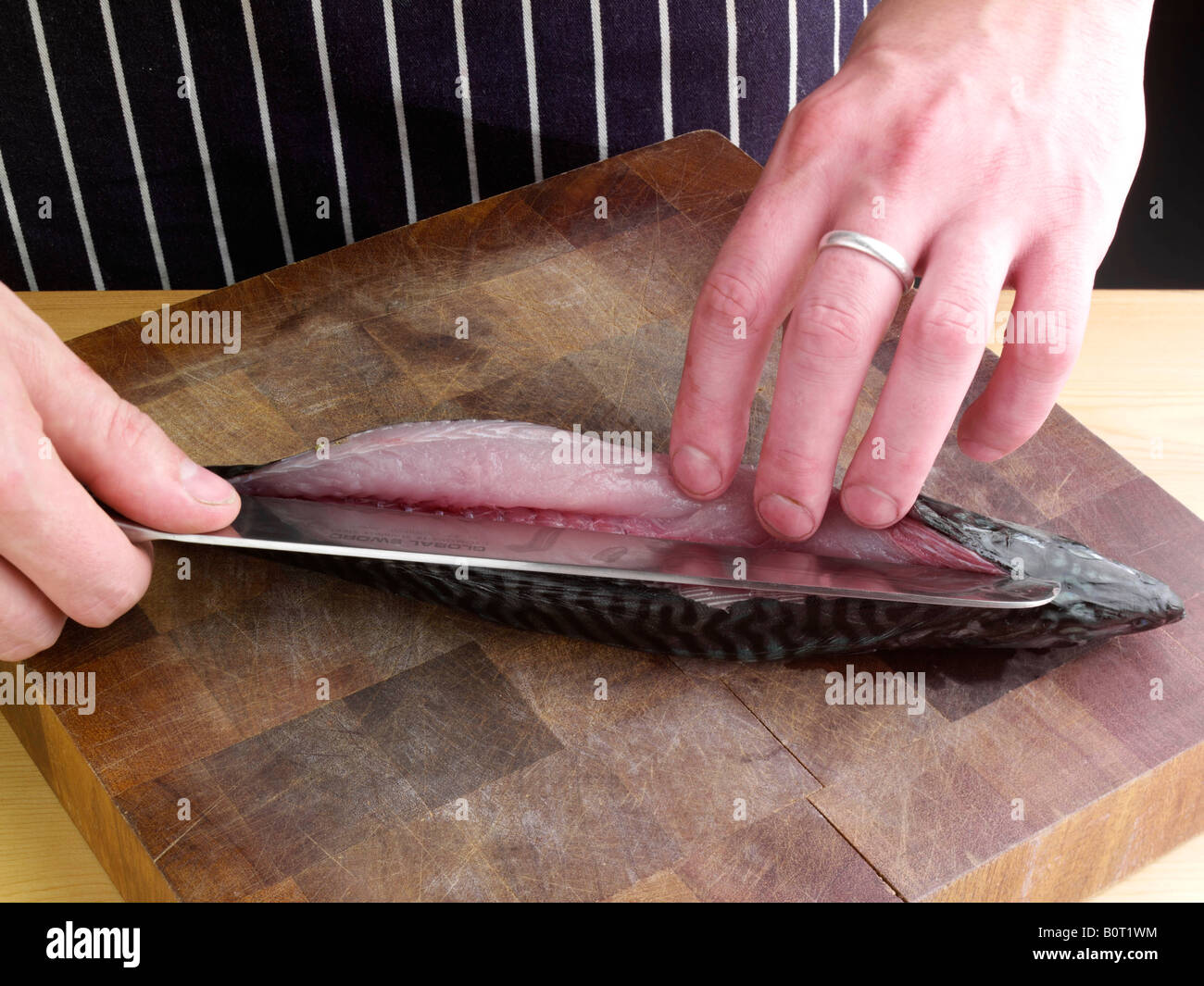 Filleting mackerel preparation cooking editorial food Stock Photo