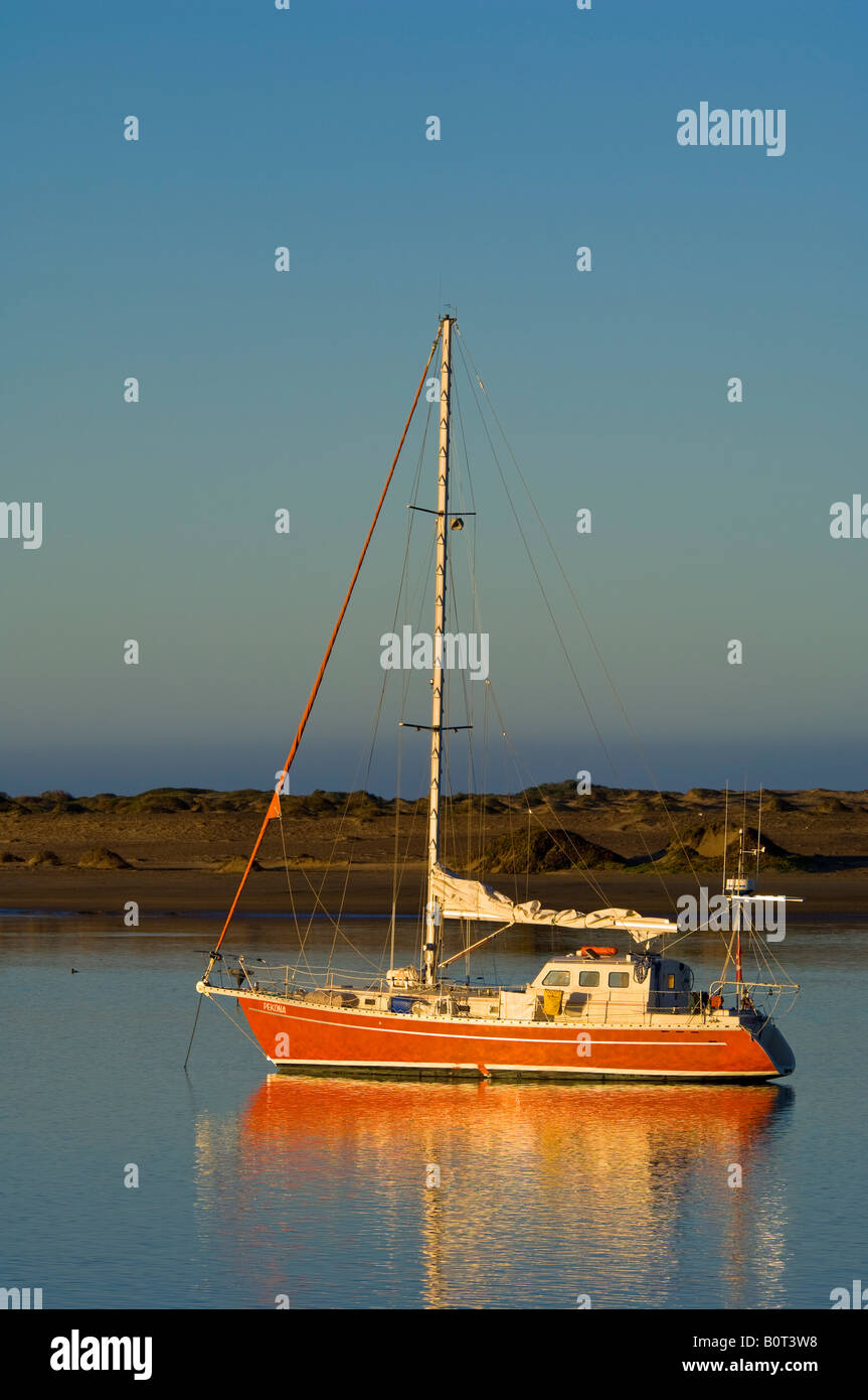 Sailboat anchored in the still calm water of Morro Bay California Stock