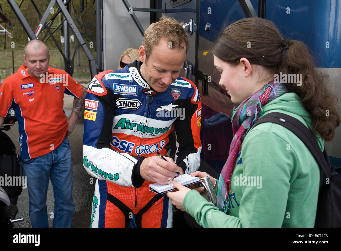 Shane Byrne signing autographs in the paddock during free practice for the BSB Championship at Brands Hatch, Kent, England. Stock Photo