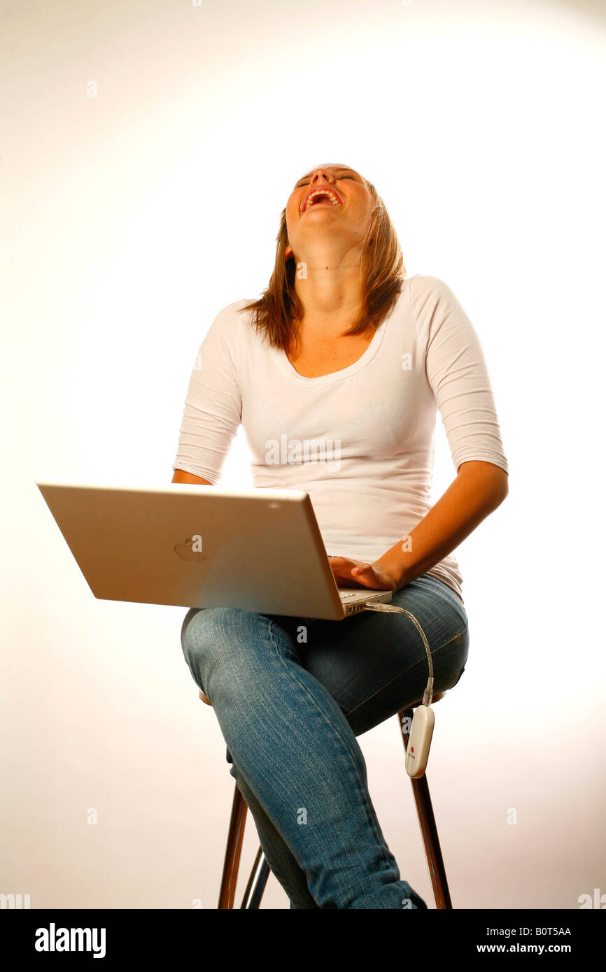 A young woman having a laugh on the internet Stock Photo