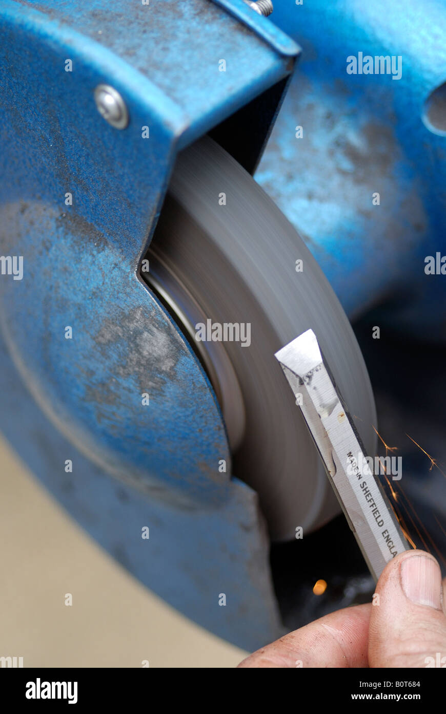 knife sharpening machine and master. Grinding machine. grinding knife using  abrasive stone Stock Photo - Alamy