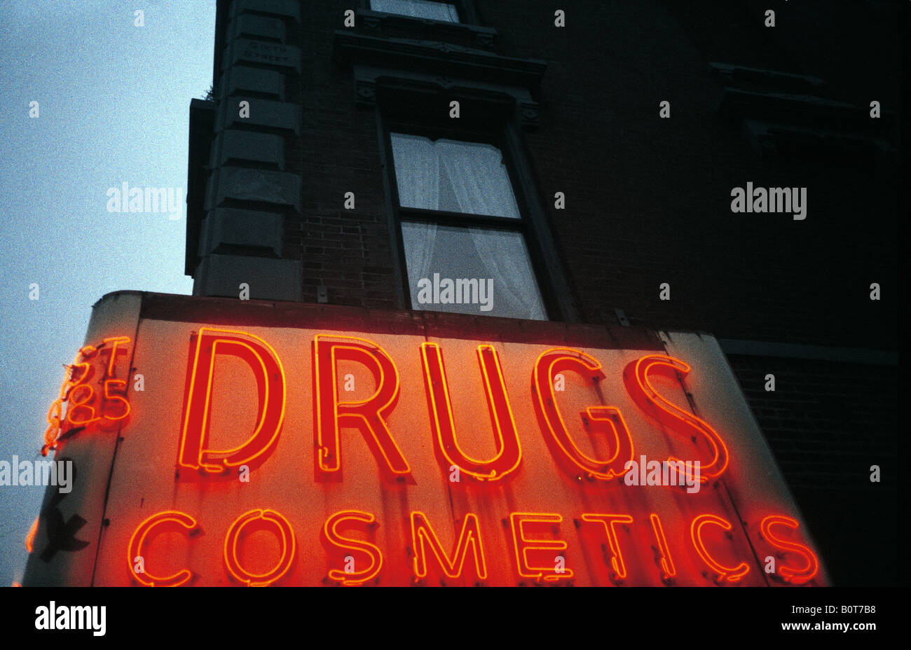a large red neon sign benath a window in new york Stock Photo