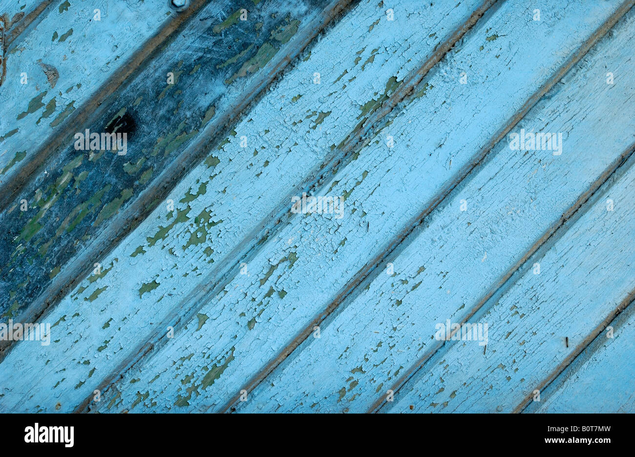 colored old boards blue color are splintering off background Stock Photo