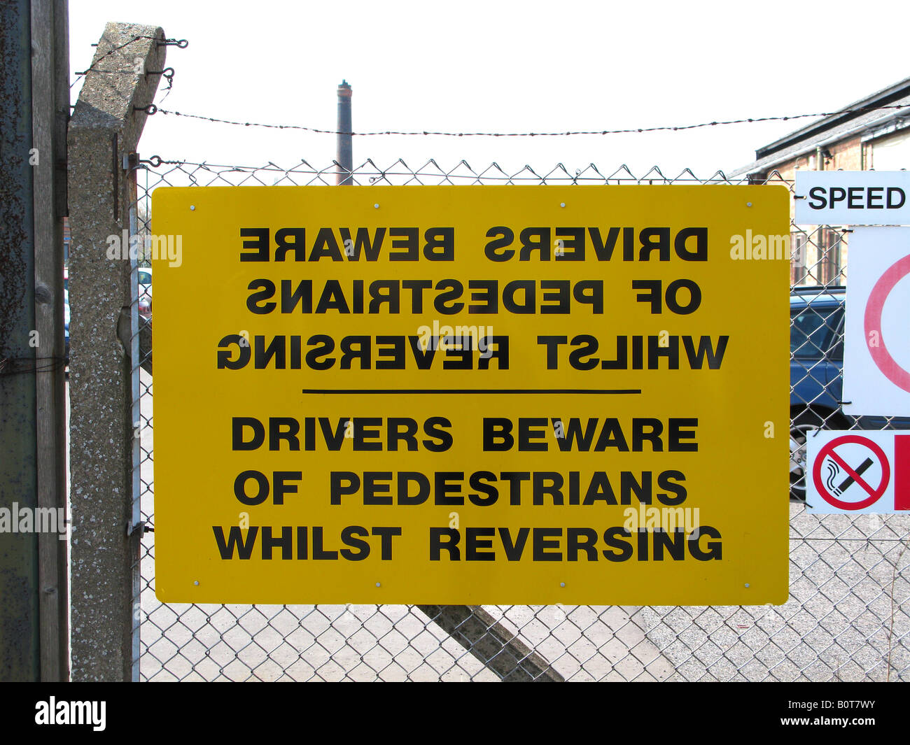 Mirror sign, confusing sign, mirror imaging a safety sign, hanging on a