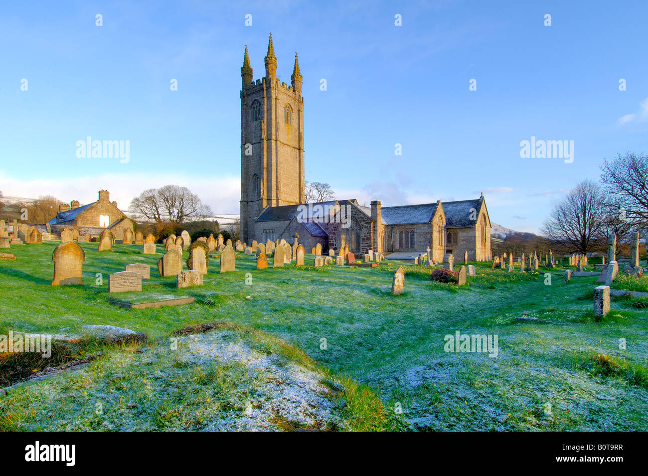 The Church of St Pancras at Widecombe in The Moor on Dartmoor first thing in the morning after a light overnight snowfall Stock Photo