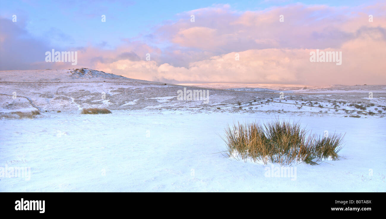 Panoramic format wintry sunrise on Dartmoor National Park with a heavy overnight snowfall Stock Photo