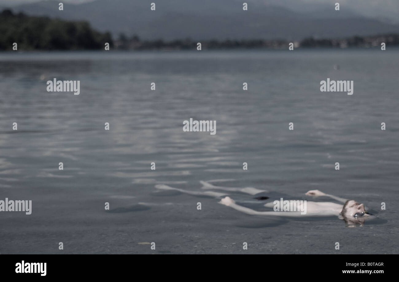 man taking a bath in a lake during sunset Stock Photo Alamy