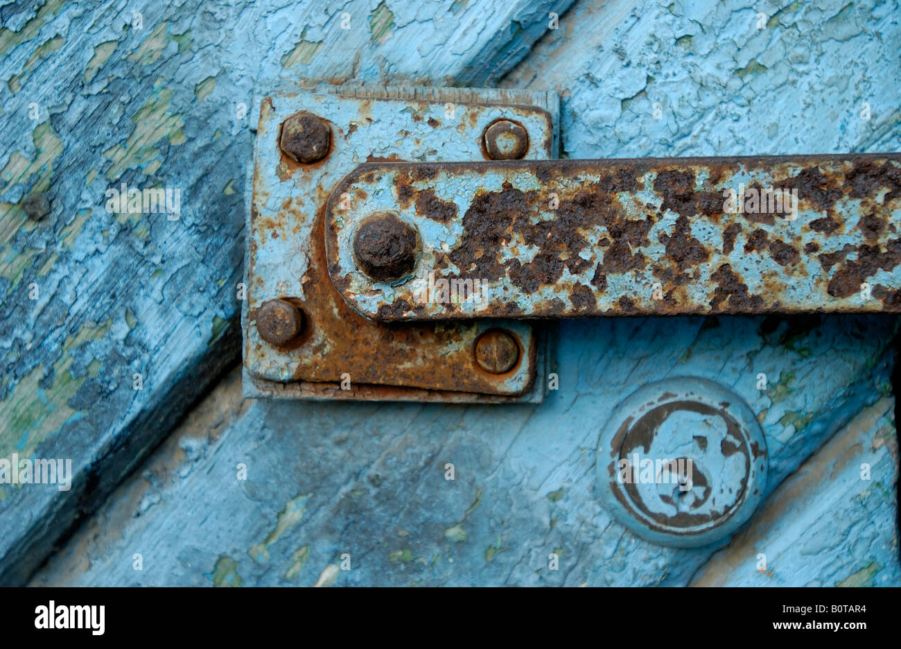 rusty lock on blue boards gate colored old boards blue color are splintering off background Stock Photo